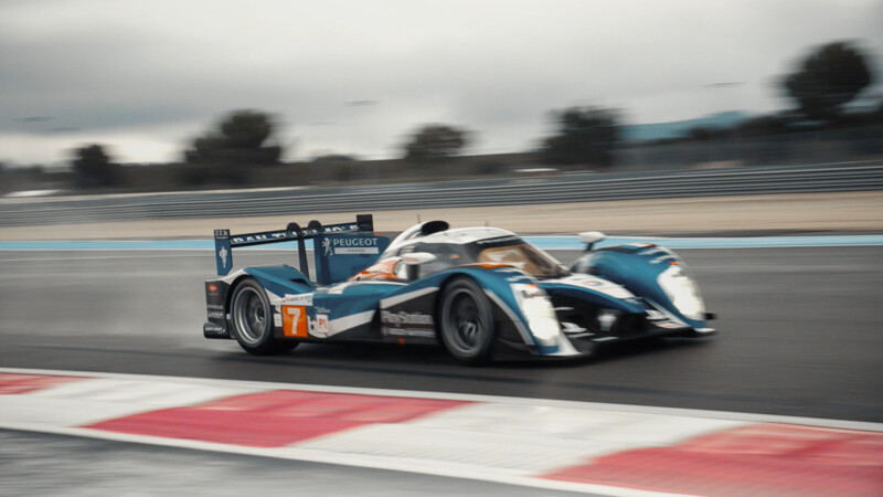 Peugeot 908 car on racing track.